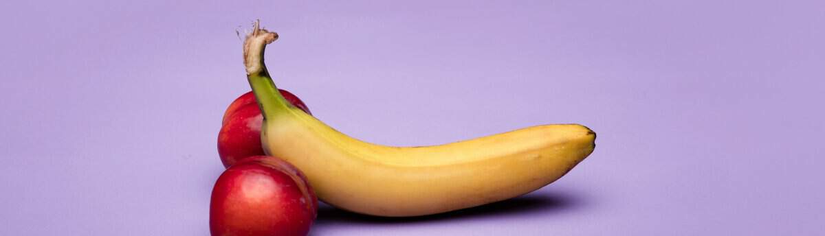 banana com bola ballbusting represetnada por uma banana e duas bolas